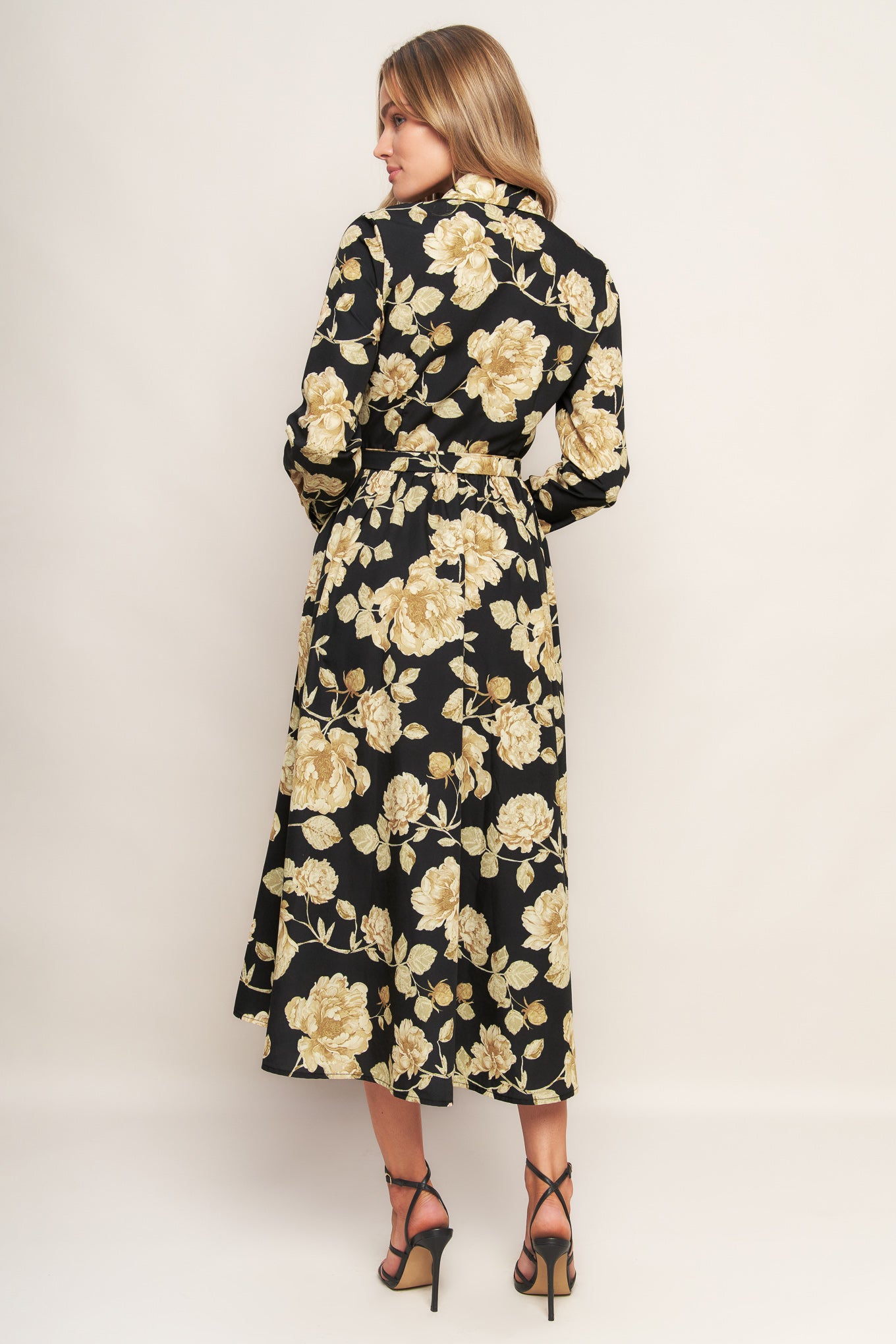 A printed woven midi dress featuring collar, long sleeve, front button down, self sash and full skirt