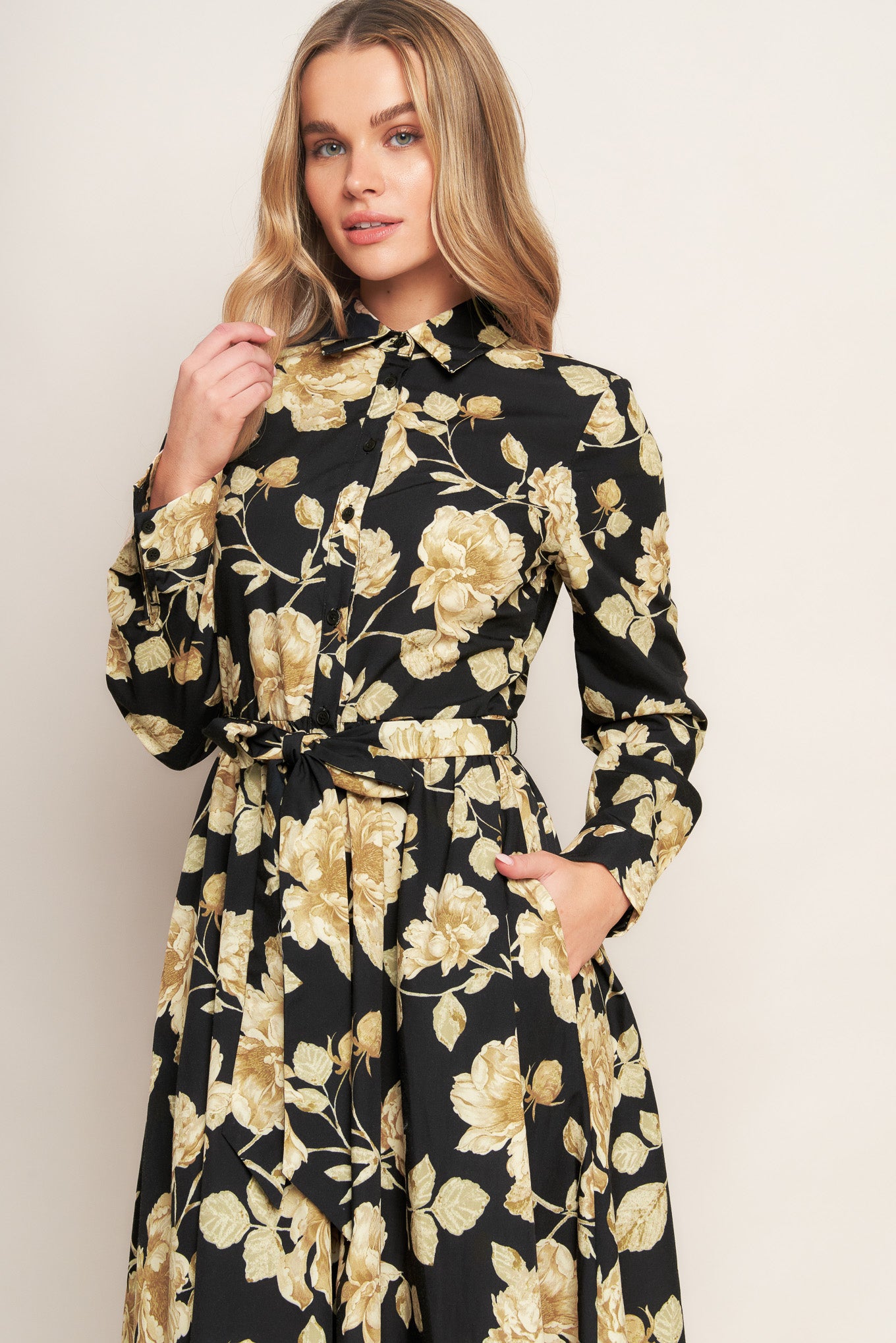 A printed woven midi dress featuring collar, long sleeve, front button down, self sash and full skirt