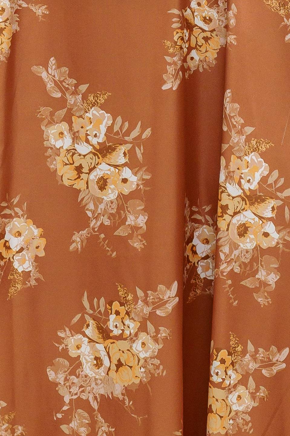 Woman wearing a long sleeve with smocked cuff bronze midi dress with floral print featuring sweetheart neckline, empire waistline, circle skirt and smocked back bodice | Flying Tomato