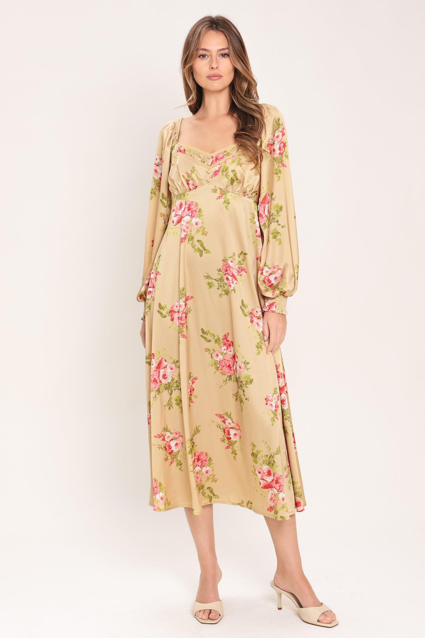 Woman wearing a long sleeve with smocked cuff champagne midi dress with floral print featuring sweetheart neckline, empire waistline, circle skirt and smocked back bodice | Flying Tomato