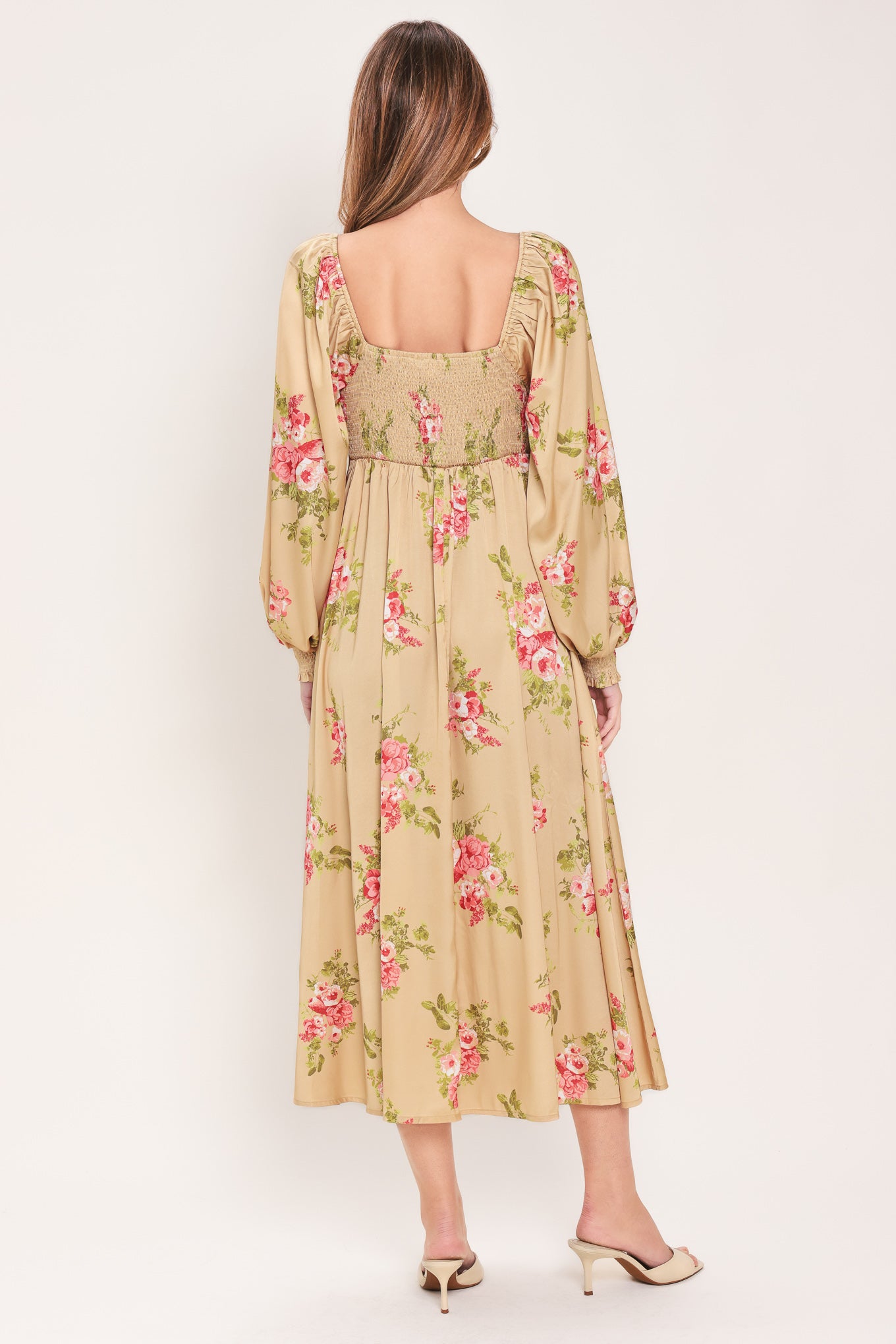 Woman wearing a long sleeve with smocked cuff champagne midi dress with floral print featuring sweetheart neckline, empire waistline, circle skirt and smocked back bodice | Flying Tomato