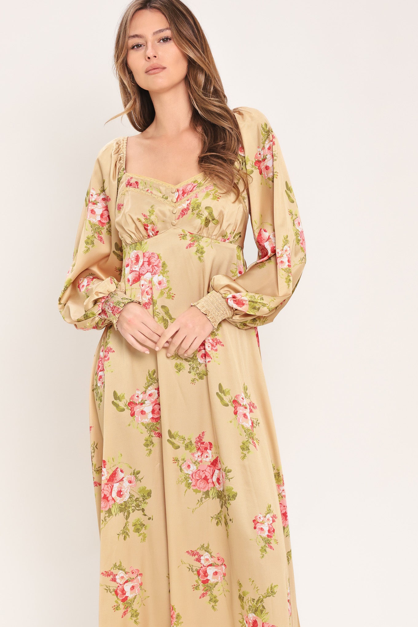 Woman wearing a long sleeve with smocked cuff champagne midi dress with floral print featuring sweetheart neckline, empire waistline, circle skirt and smocked back bodice | Flying Tomato