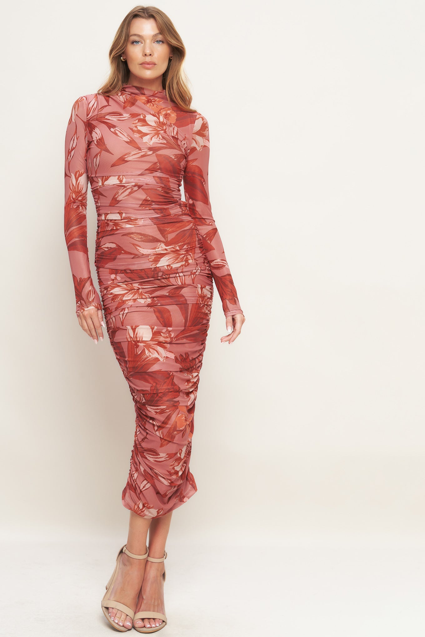 A printed power mesh midi dress featuring high neckline, long sleeve, side shirring and back zipper closure
