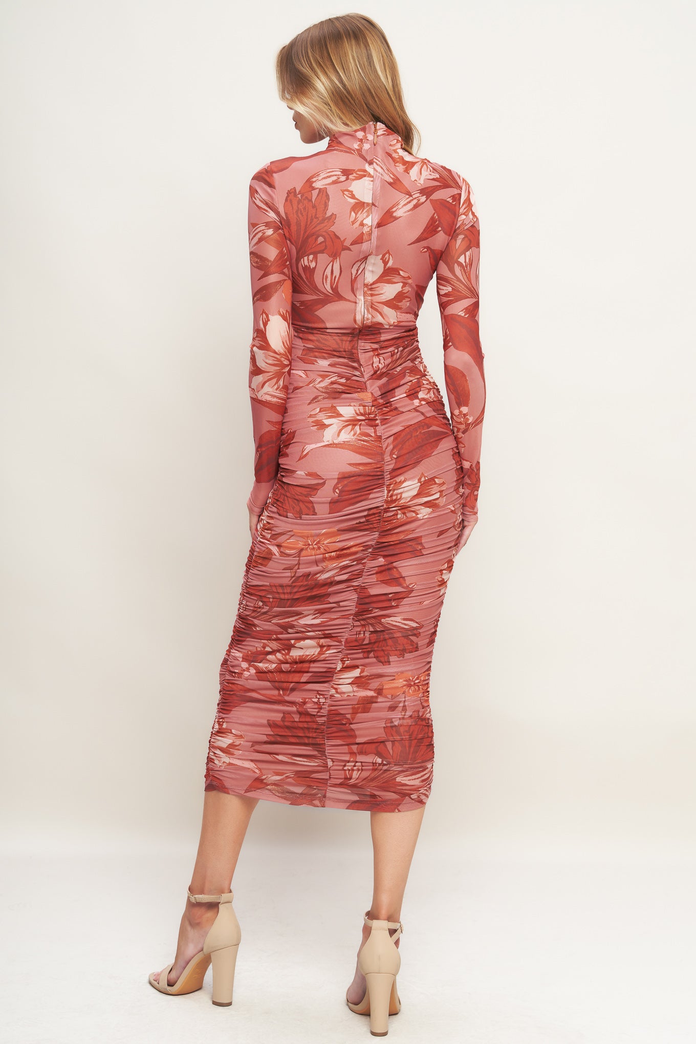 A printed power mesh midi dress featuring high neckline, long sleeve, side shirring and back zipper closure