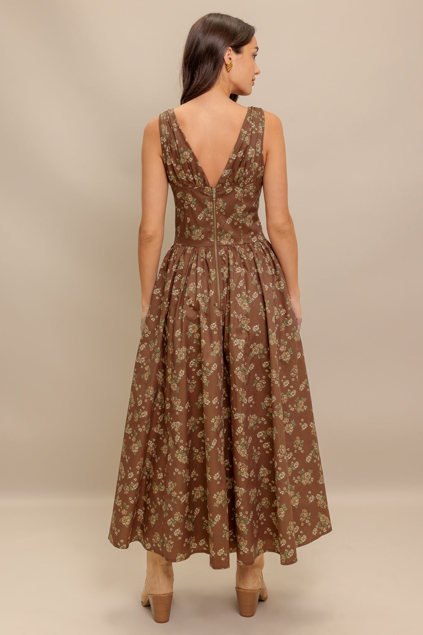 A printed woven midi dress featuring V neckline with bow tie, basque waistline, full skirt and back zipper closure