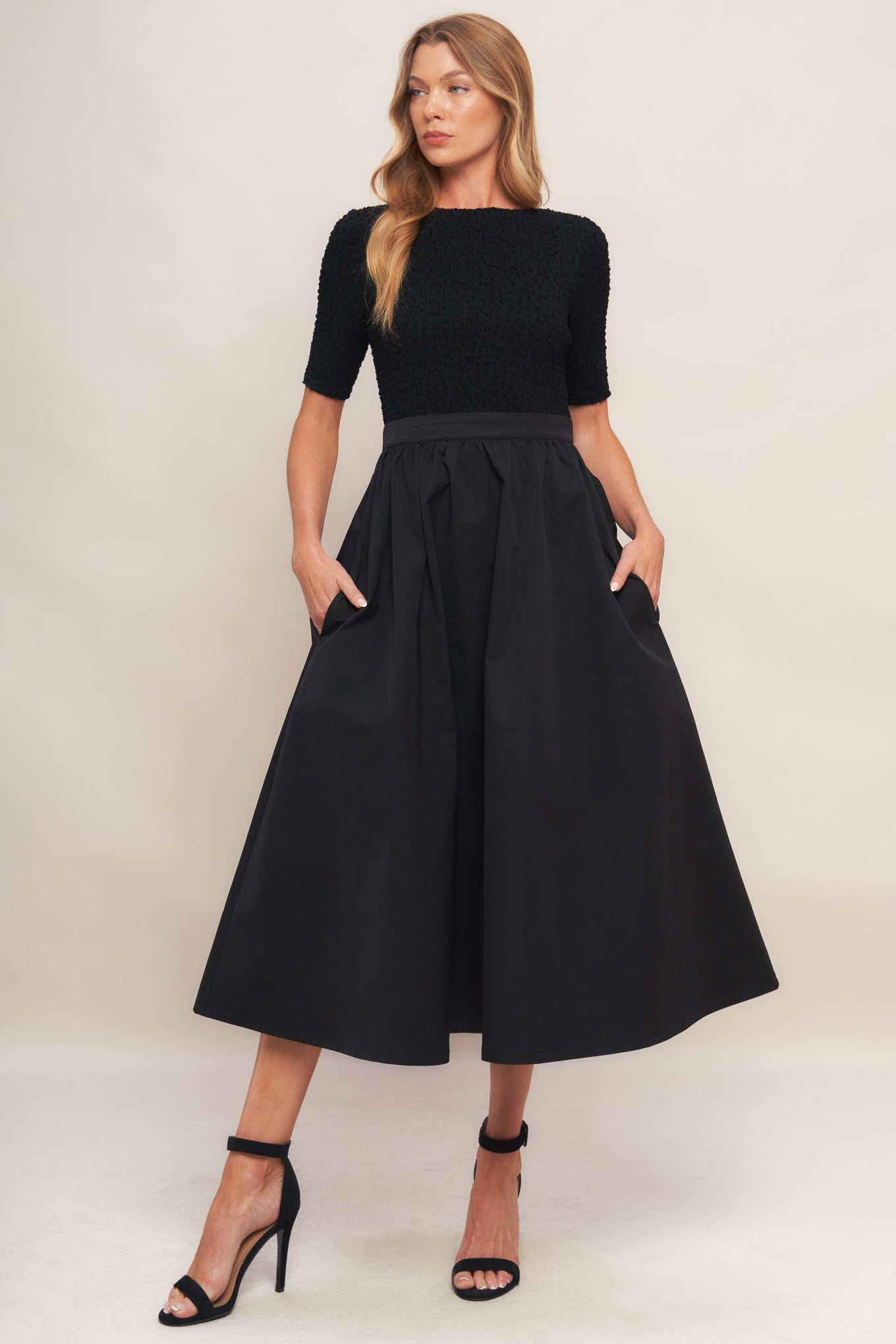 A solid woven midi dress featuring textured woven top with round neckline and short sleeve, full woven skirt and back zipper closure