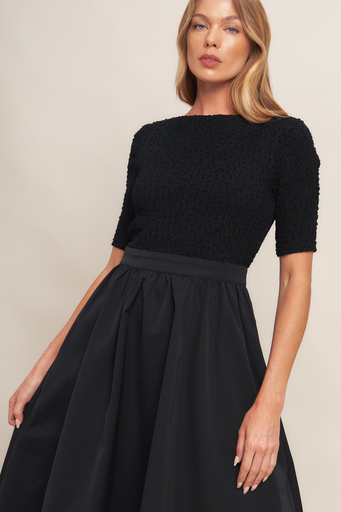 A solid woven midi dress featuring textured woven top with round neckline and short sleeve, full woven skirt and back zipper closure