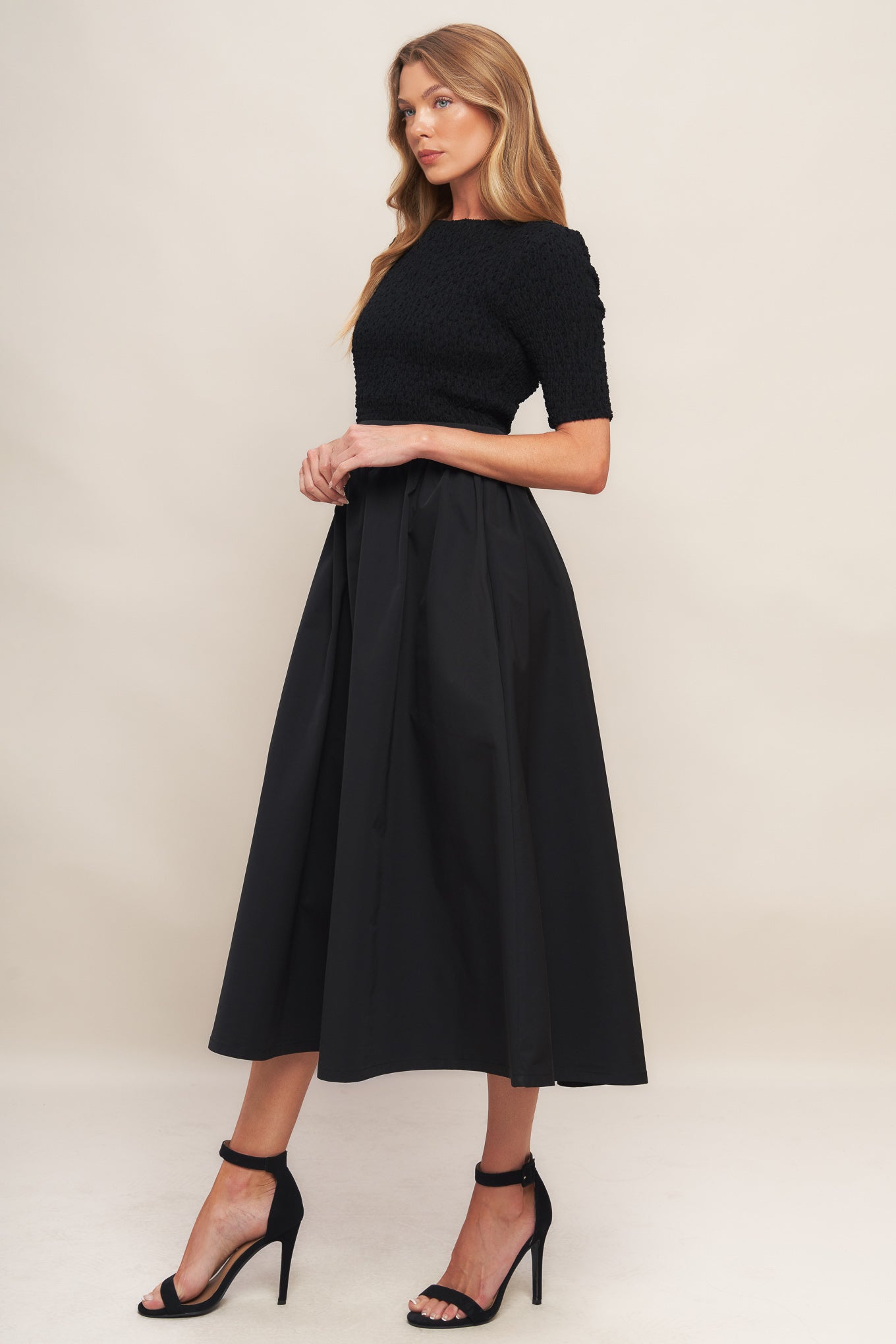 A solid woven midi dress featuring textured woven top with round neckline and short sleeve, full woven skirt and back zipper closure