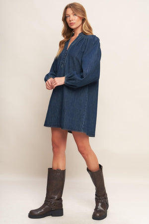 A washed denim mini dress featuring round neckline with V front, button down and long sleeve