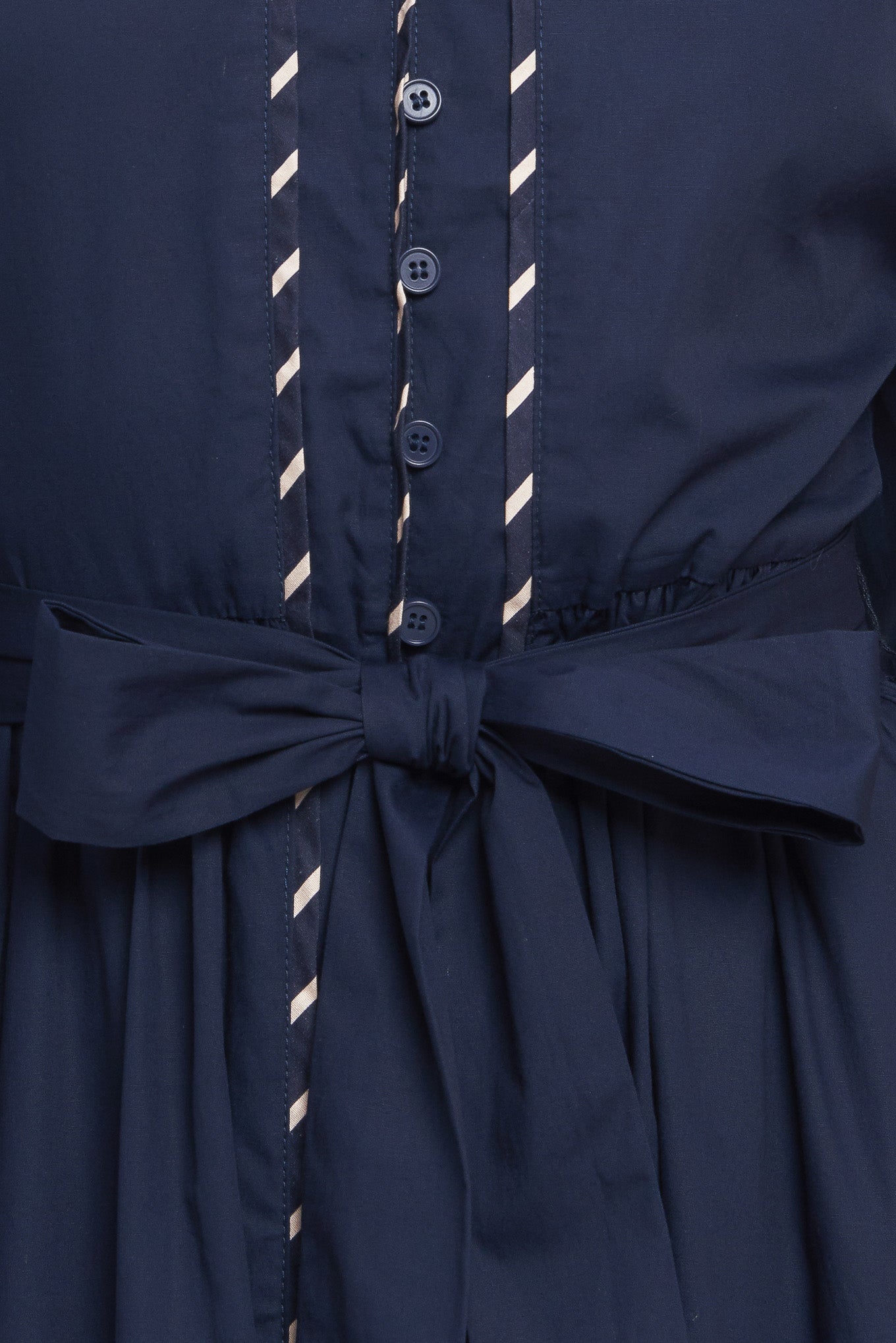 A solid woven midi dress featuring high neckline with V front, long sleeve with cuff, self sash tie, front button down and contrasting binding