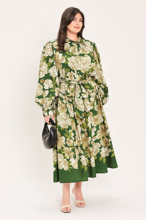 A woman wearing a long-sleeve midi dress with a green and cream floral print | Flying Tomato Curve