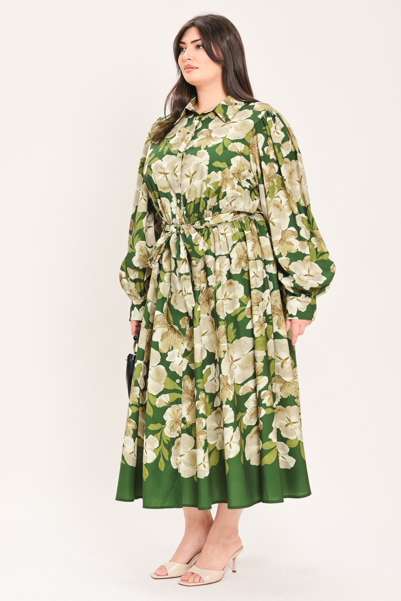 A woman wearing a long-sleeve midi dress with a green and cream floral print | Flying Tomato Curve