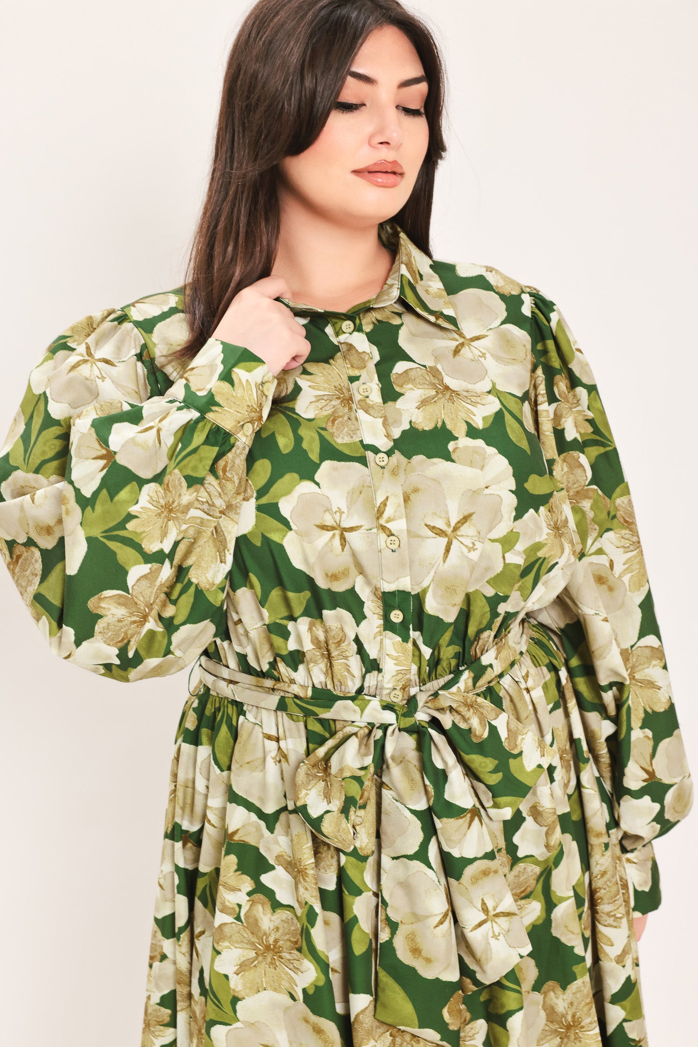 A woman wearing a long-sleeve midi dress with a green and cream floral print | Flying Tomato Curve
