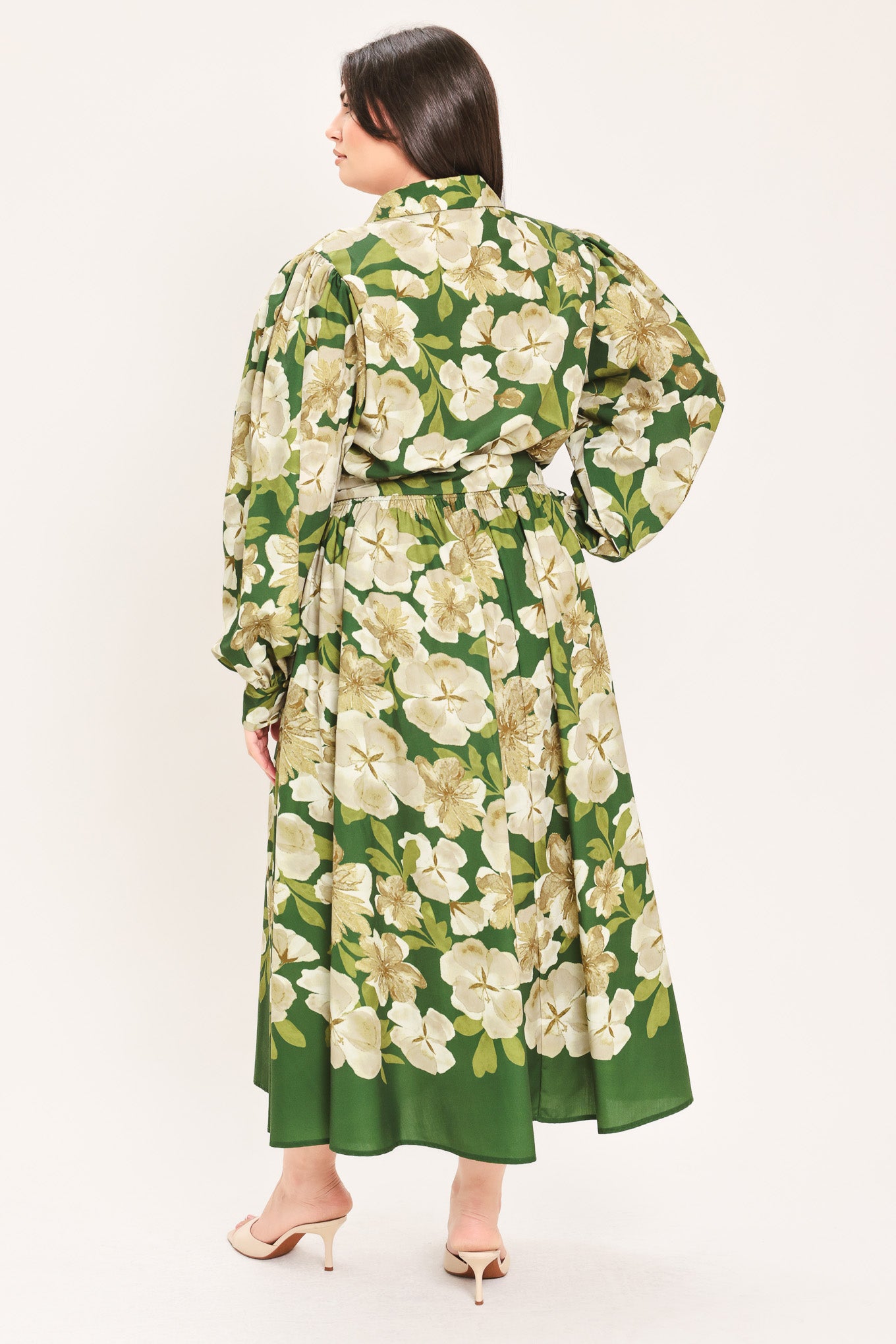 A woman wearing a long-sleeve midi dress with a green and cream floral print | Flying Tomato Curve