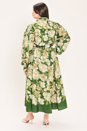 A woman wearing a long-sleeve midi dress with a green and cream floral print | Flying Tomato Curve