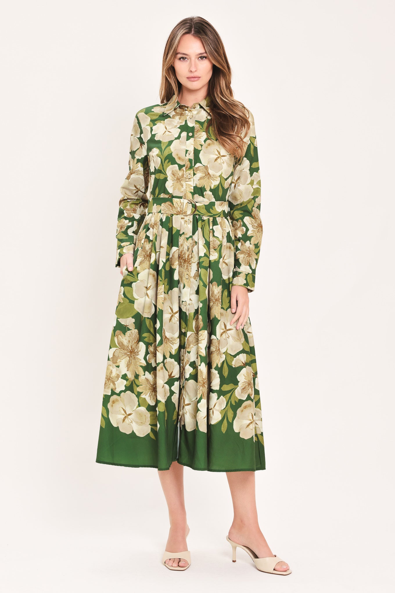 A woman wearing a long-sleeve midi dress with a green and cream floral print | Flying Tomato