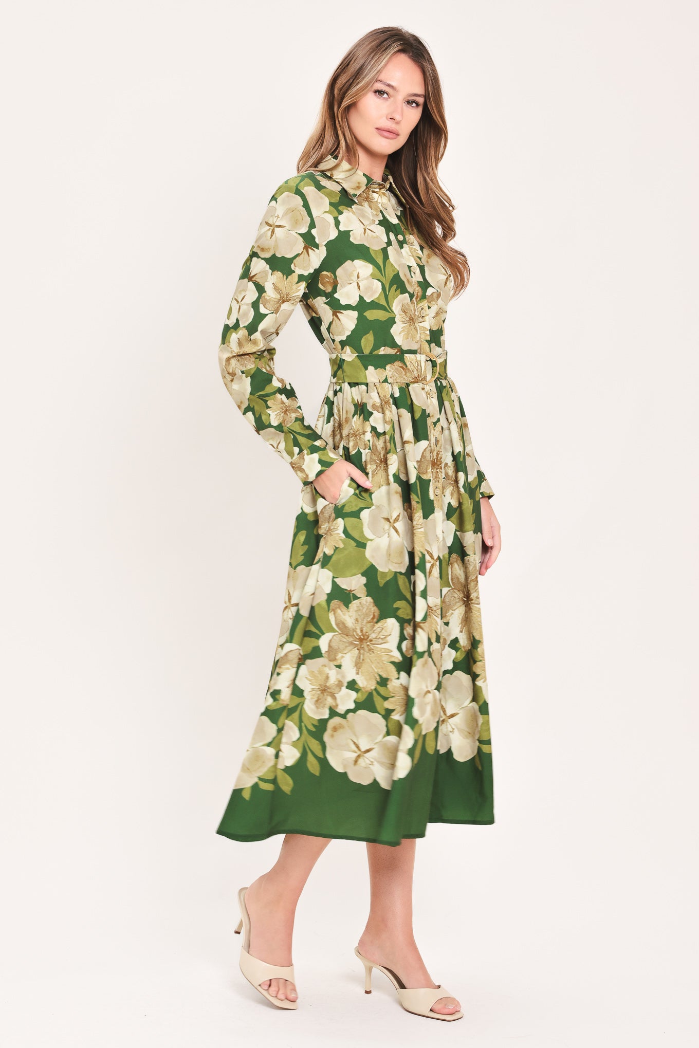 A woman wearing a long-sleeve midi dress with a green and cream floral print | Flying Tomato