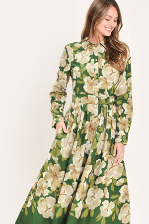 A woman wearing a long-sleeve midi dress with a green and cream floral print | Flying Tomato