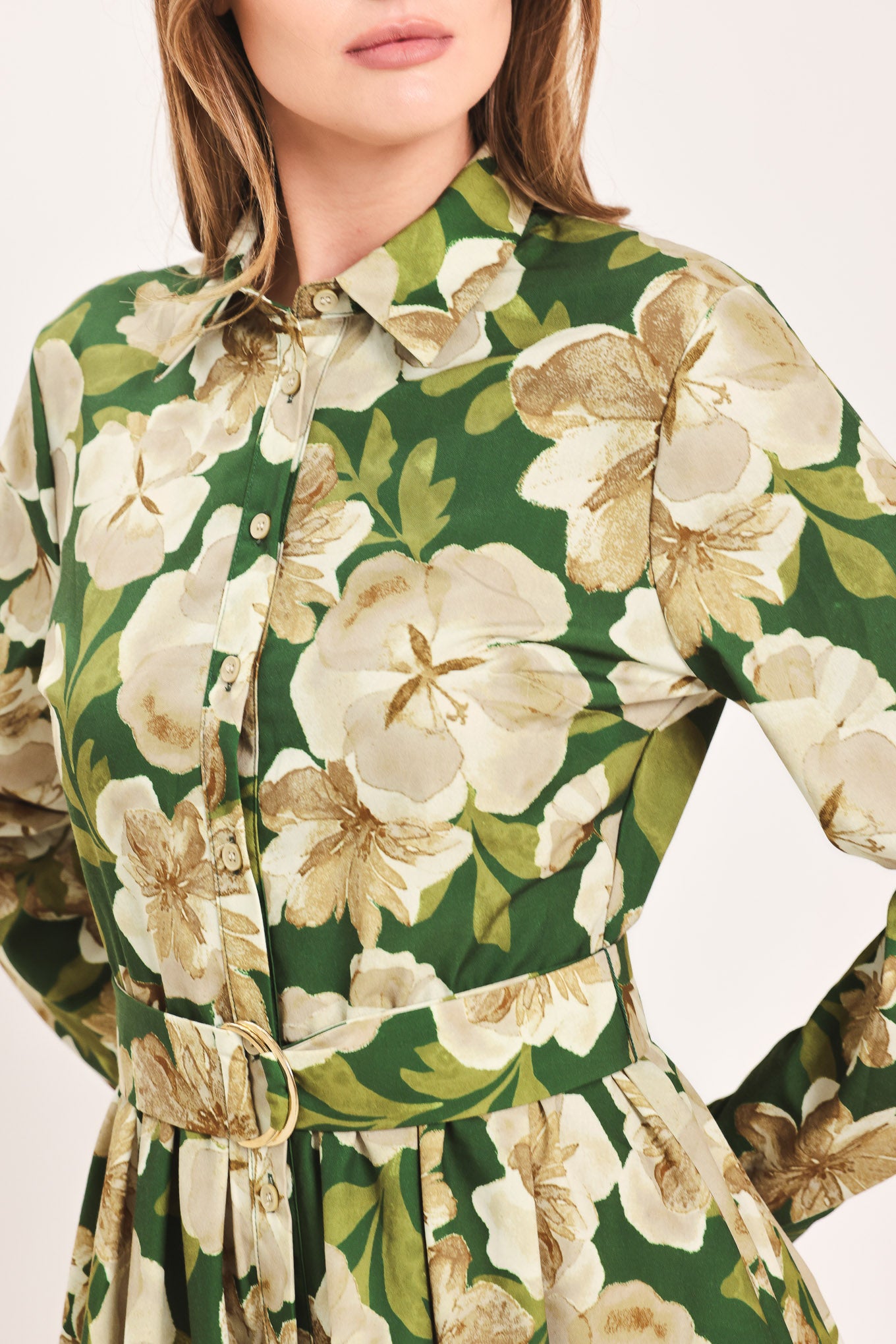 A woman wearing a long-sleeve midi dress with a green and cream floral print | Flying Tomato