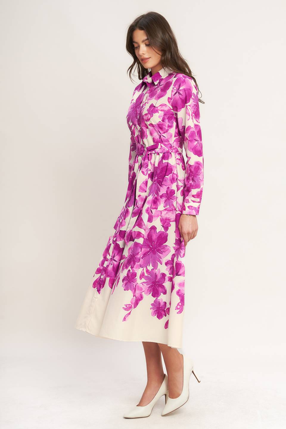 A woman wearing a long-sleeve midi dress with a fuchsia and cream floral print | Flying Tomato