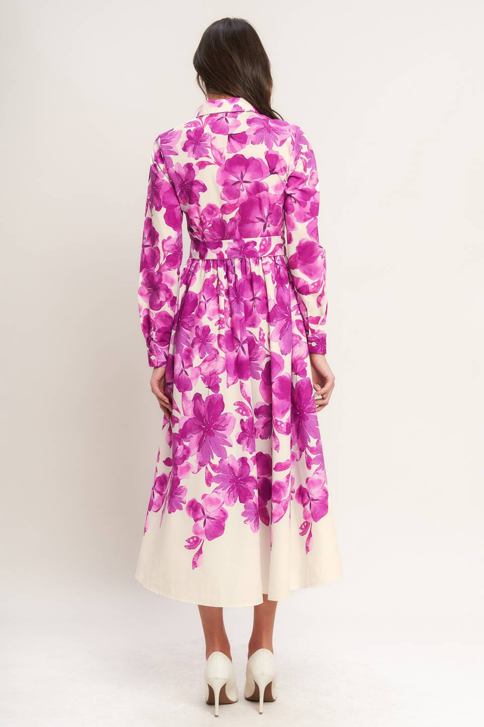A woman wearing a long-sleeve midi dress with a fuchsia and cream floral print | Flying Tomato