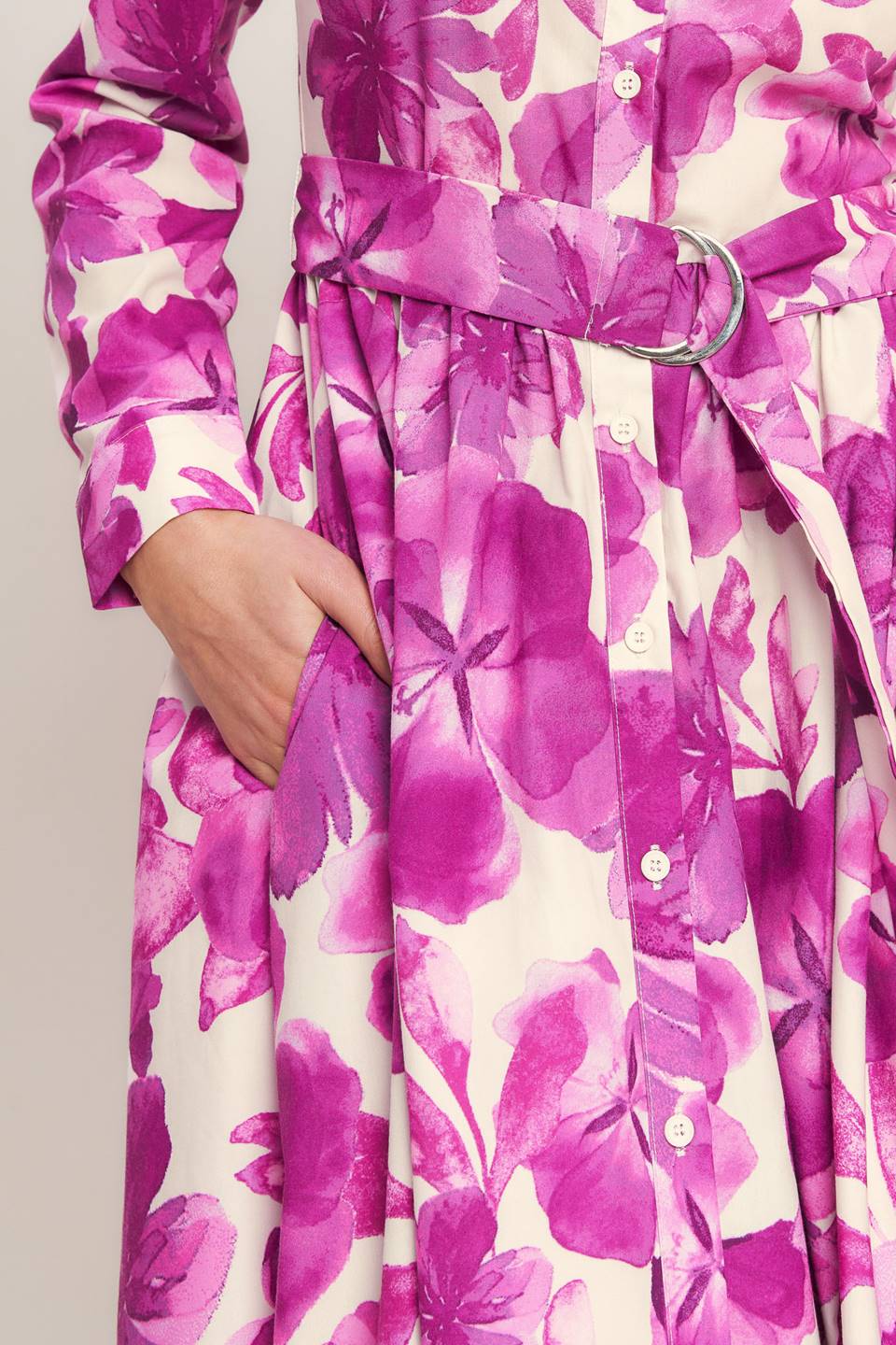 A woman wearing a long-sleeve midi dress with a fuchsia and cream floral print | Flying Tomato