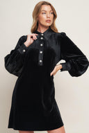 A solid velvet mini dress featuring contrasting collar and placet with jewel button and long sleeve with cuff