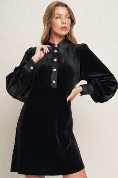 A solid velvet mini dress featuring contrasting collar and placet with jewel button and long sleeve with cuff