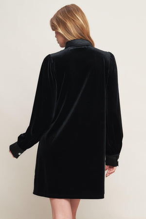 A solid velvet mini dress featuring contrasting collar and placet with jewel button and long sleeve with cuff