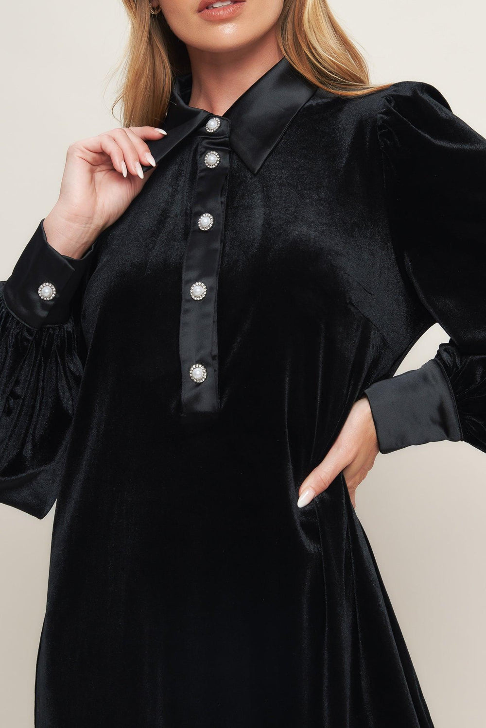 A solid velvet mini dress featuring contrasting collar and placet with jewel button and long sleeve with cuff