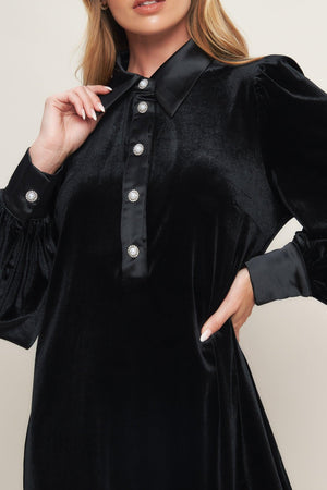 A solid velvet mini dress featuring contrasting collar and placet with jewel button and long sleeve with cuff
