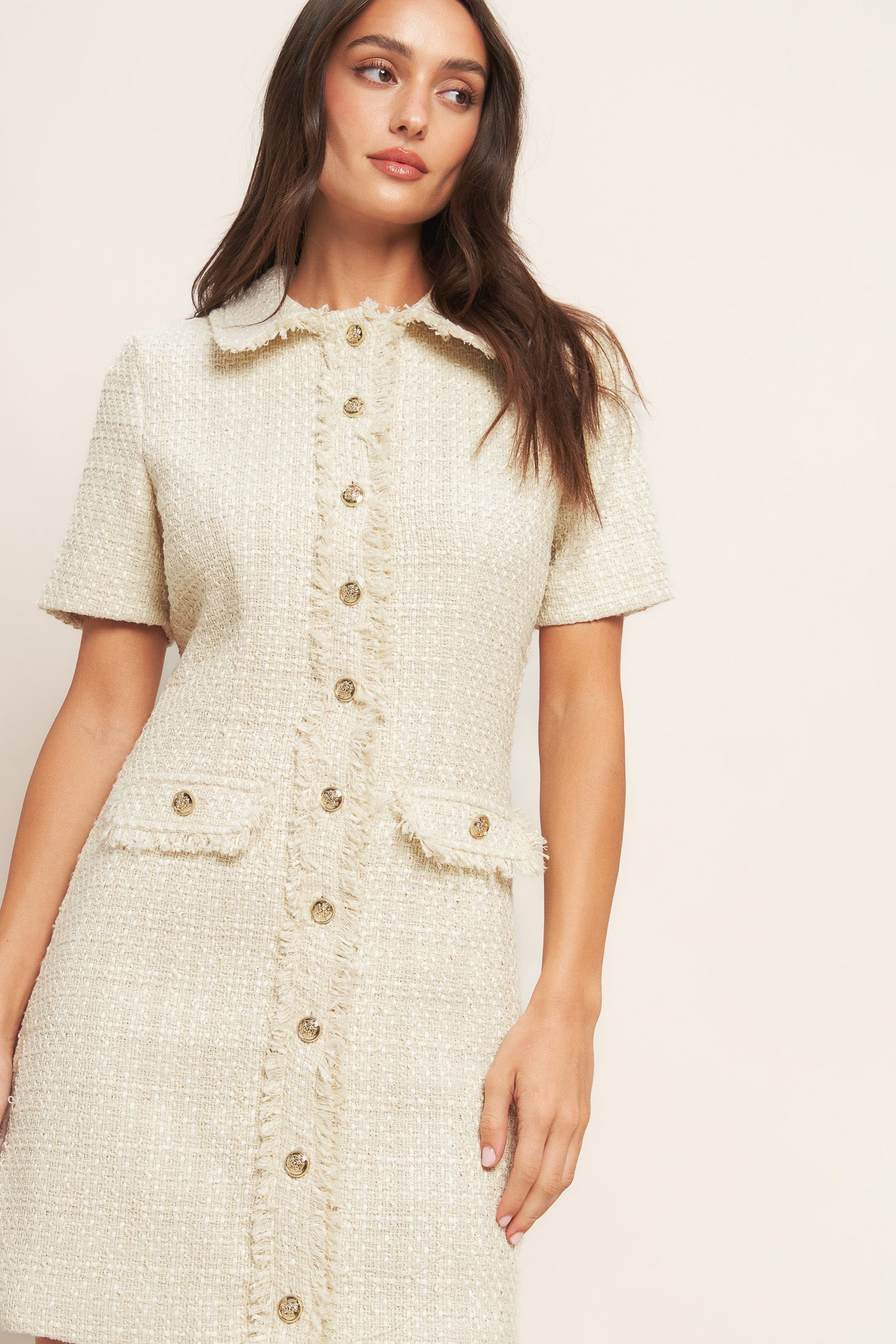 A tweed mini dress featuring frayed collar and placket, short sleeve and button down closure