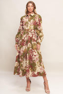 A printed woven midi dress featuring collar, long sleeve with cuff, front button down closure, self belt and full skirt