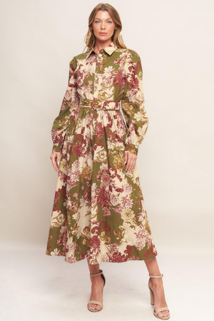 A printed woven midi dress featuring collar, long sleeve with cuff, front button down closure, self belt and full skirt