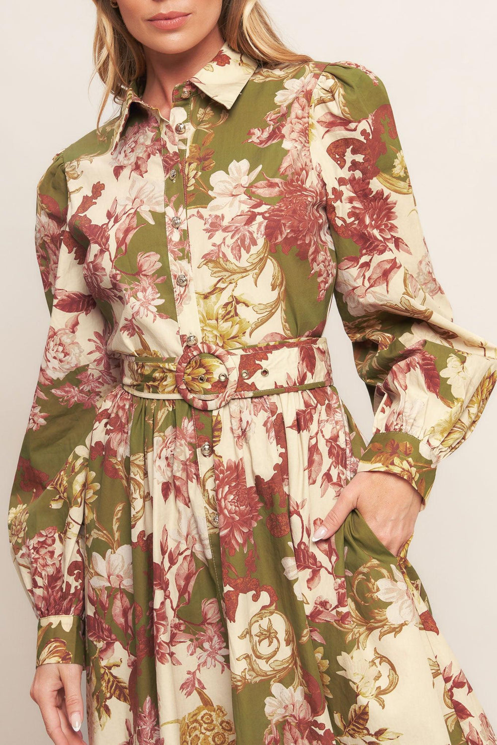A printed woven midi dress featuring collar, long sleeve with cuff, front button down closure, self belt and full skirt