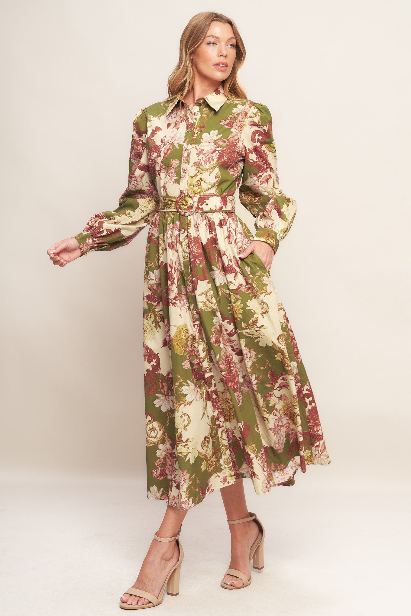 A printed woven midi dress featuring collar, long sleeve with cuff, front button down closure, self belt and full skirt