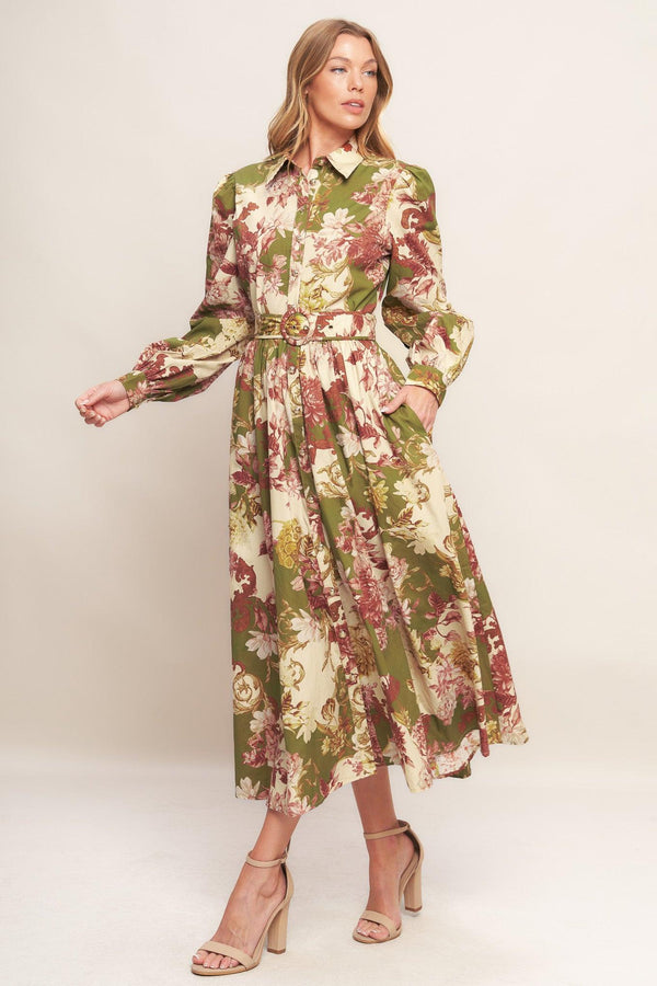 A printed woven midi dress featuring collar, long sleeve with cuff, front button down closure, self belt and full skirt