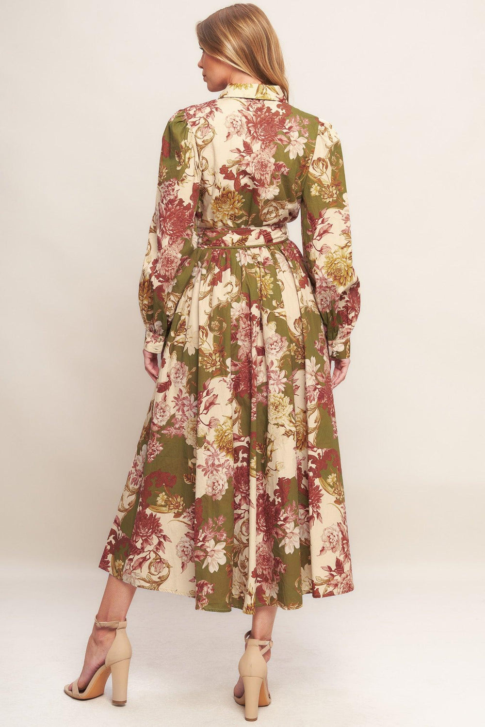 A printed woven midi dress featuring collar, long sleeve with cuff, front button down closure, self belt and full skirt