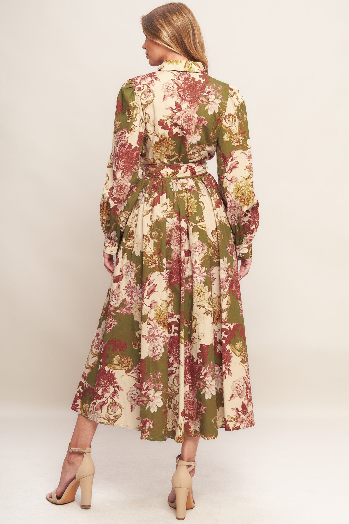 A printed woven midi dress featuring collar, long sleeve with cuff, front button down closure, self belt and full skirt