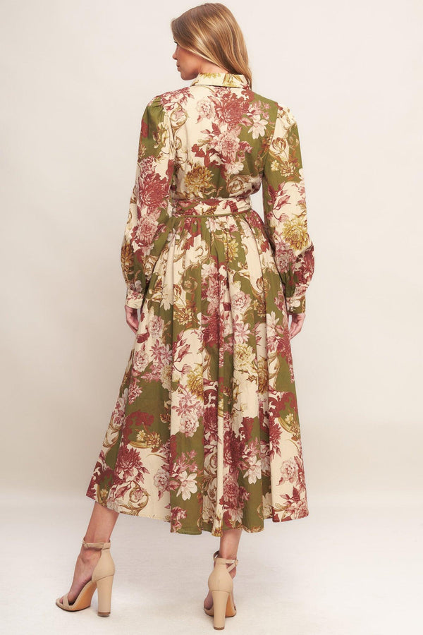 A printed woven midi dress featuring collar, long sleeve with cuff, front button down closure, self belt and full skirt