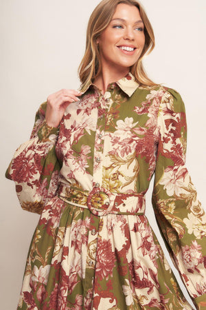 A printed woven midi dress featuring collar, long sleeve with cuff, front button down closure, self belt and full skirt