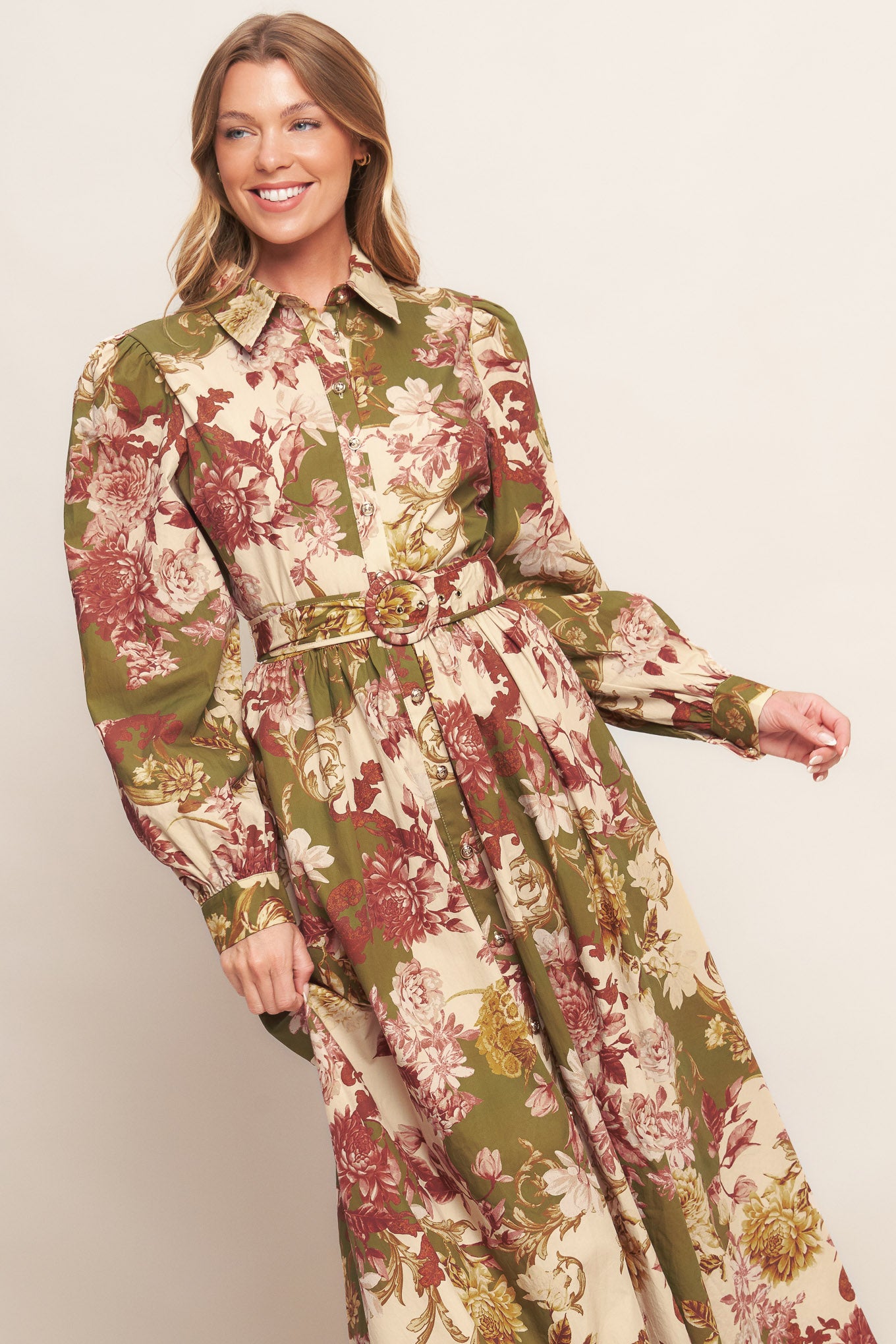 A printed woven midi dress featuring collar, long sleeve with cuff, front button down closure, self belt and full skirt