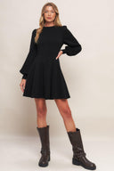 A solid heavy knit mini dress featuring round neckline, long sleeve with cuff, circle skirt and back zipper closure
