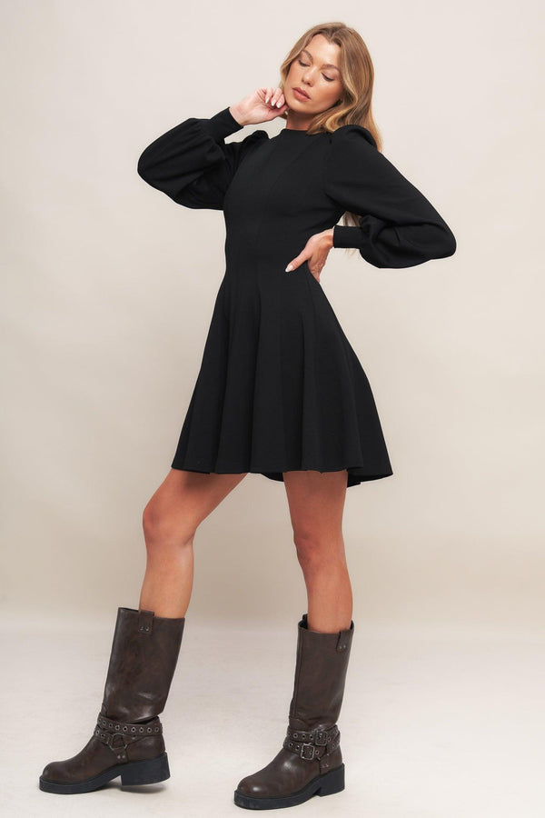 A solid heavy knit mini dress featuring round neckline, long sleeve with cuff, circle skirt and back zipper closure