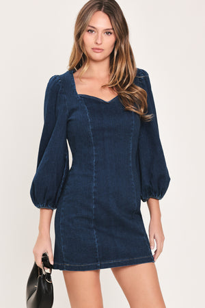 Woman wearing a 3/4 balloon sleeve denim mini dress with a sweetheart neckline | Flying Tomato