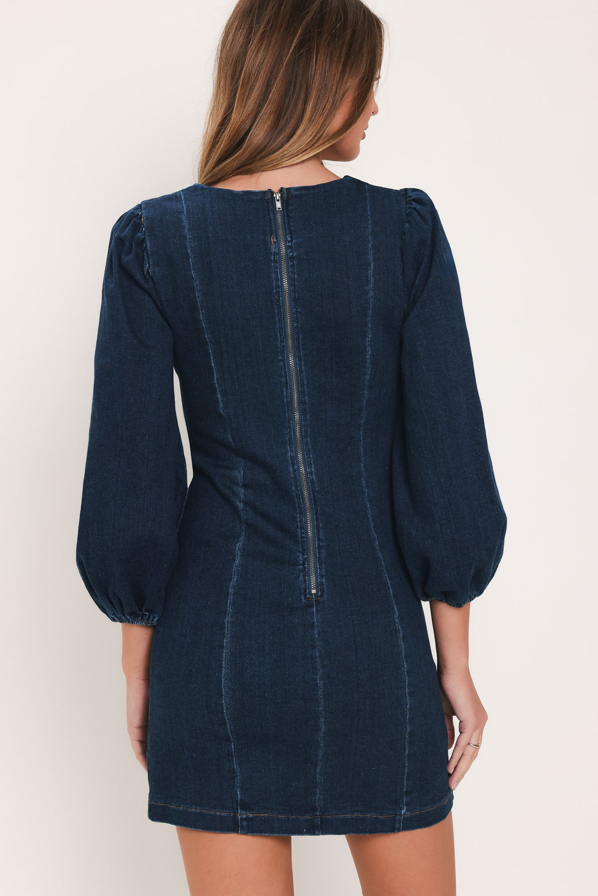 Woman wearing a 3/4 balloon sleeve denim mini dress with a sweetheart neckline | Flying Tomato