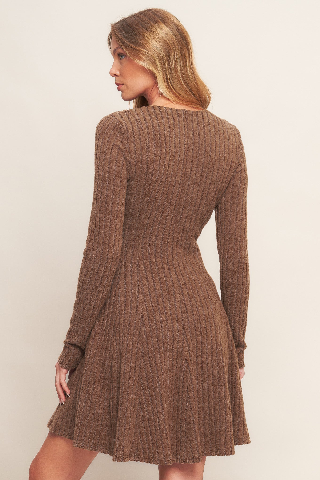 A brushed ribbed knit mini dress featuring round neckline, long sleeve, circle skirt and back zipper closure