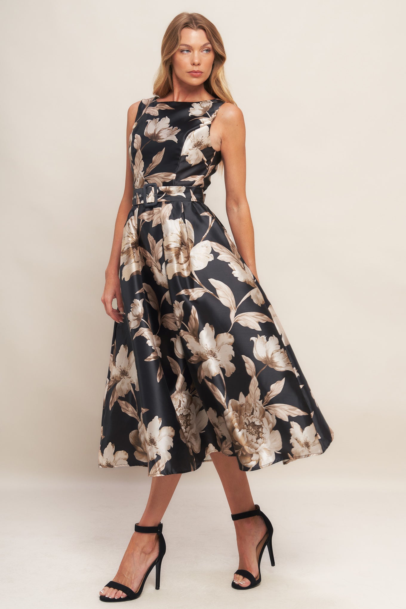 A printed woven midi dress featuring wide neckline, sleeveless, self belt, full skirt and back zipper closure