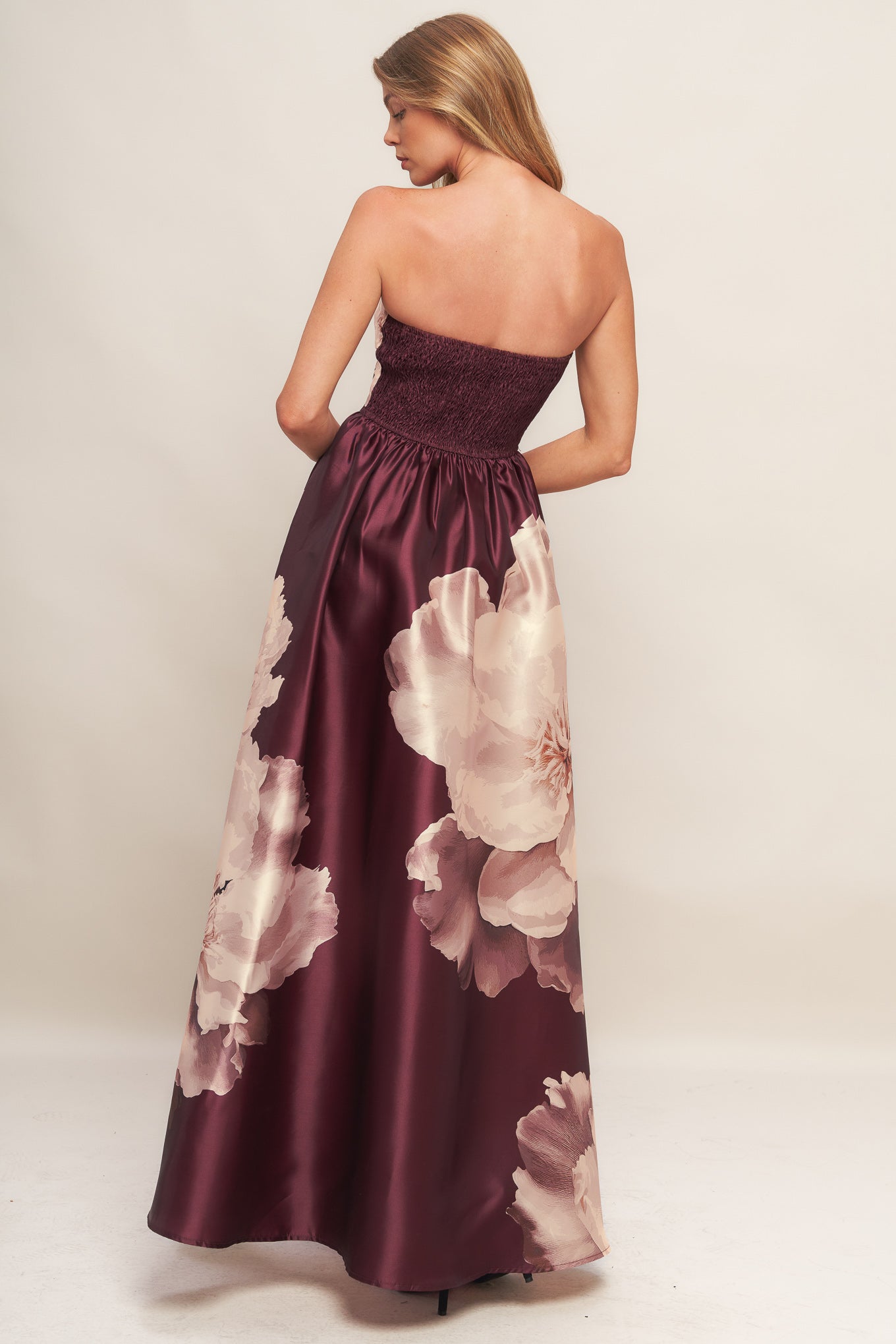 A printed woven maxi dress featuring strapless neckline, full skirt and smocked back bodice