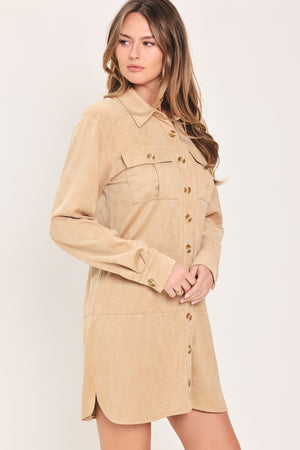Woman wearing a long sleeve beige suede mini dress with buttons along the front, collar, and self tie matching belt | Flying Tomato